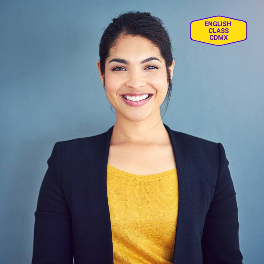 Smiling young professional woman in a business-casual outfit, representing confidence in goal setting and project management skills developed through English coaching at English Class CDMX.