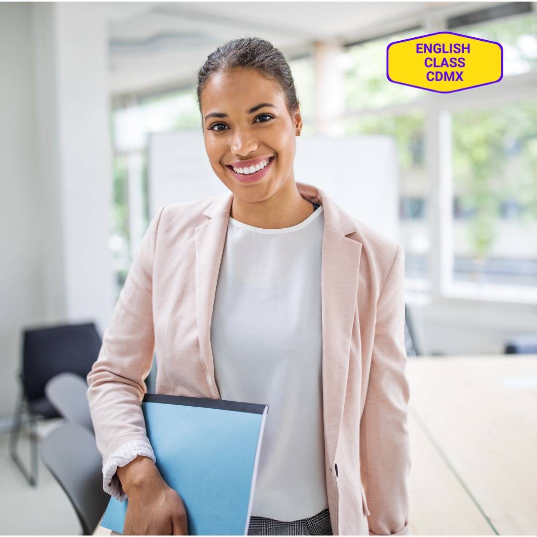 Smiling young professional woman holding a folder, symbolizing the enhancement of essential soft skills through English coaching at English Class CDMX.