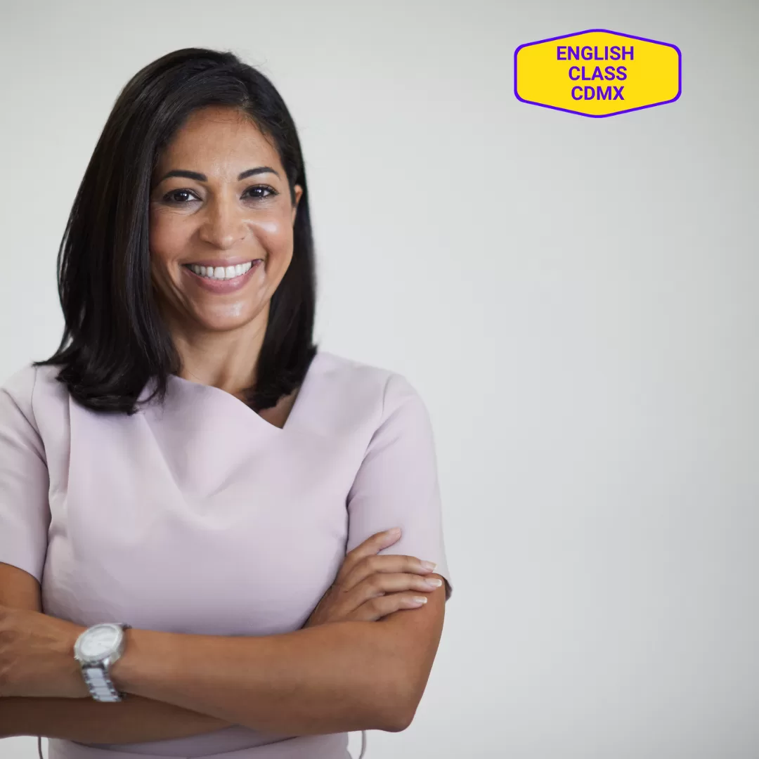 Confident woman in professional attire standing with arms crossed, featuring the English Class CDMX logo in the background