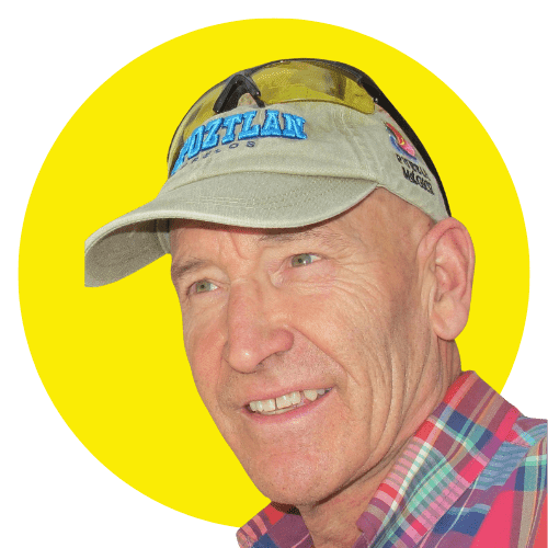 Close-up portrait of Robert Erickson wearing a cap and plaid shirt, set against a bright yellow background