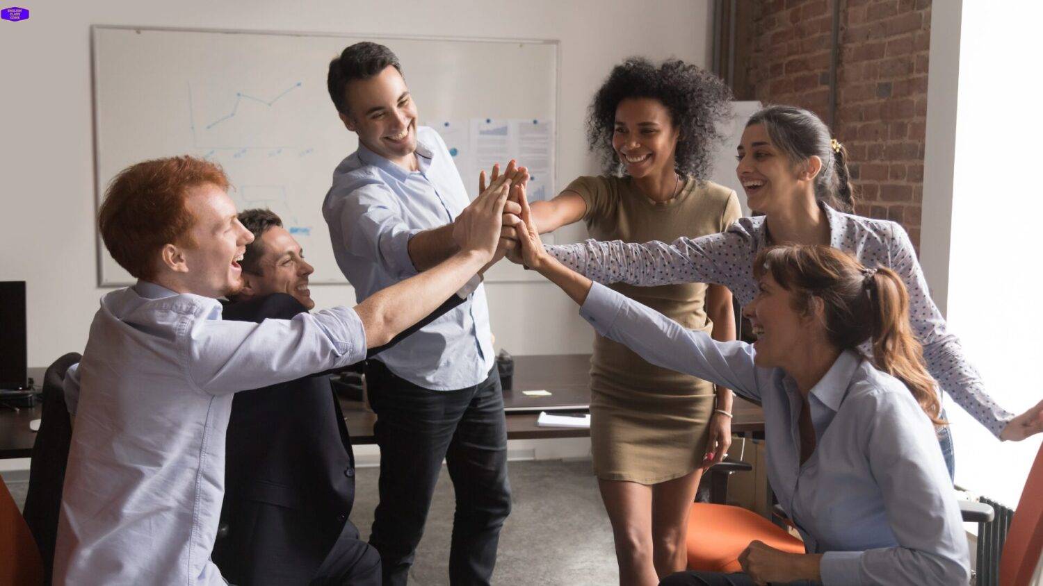 A diverse group of professionals celebrating a successful teamwork session, symbolizing growth and achievement.